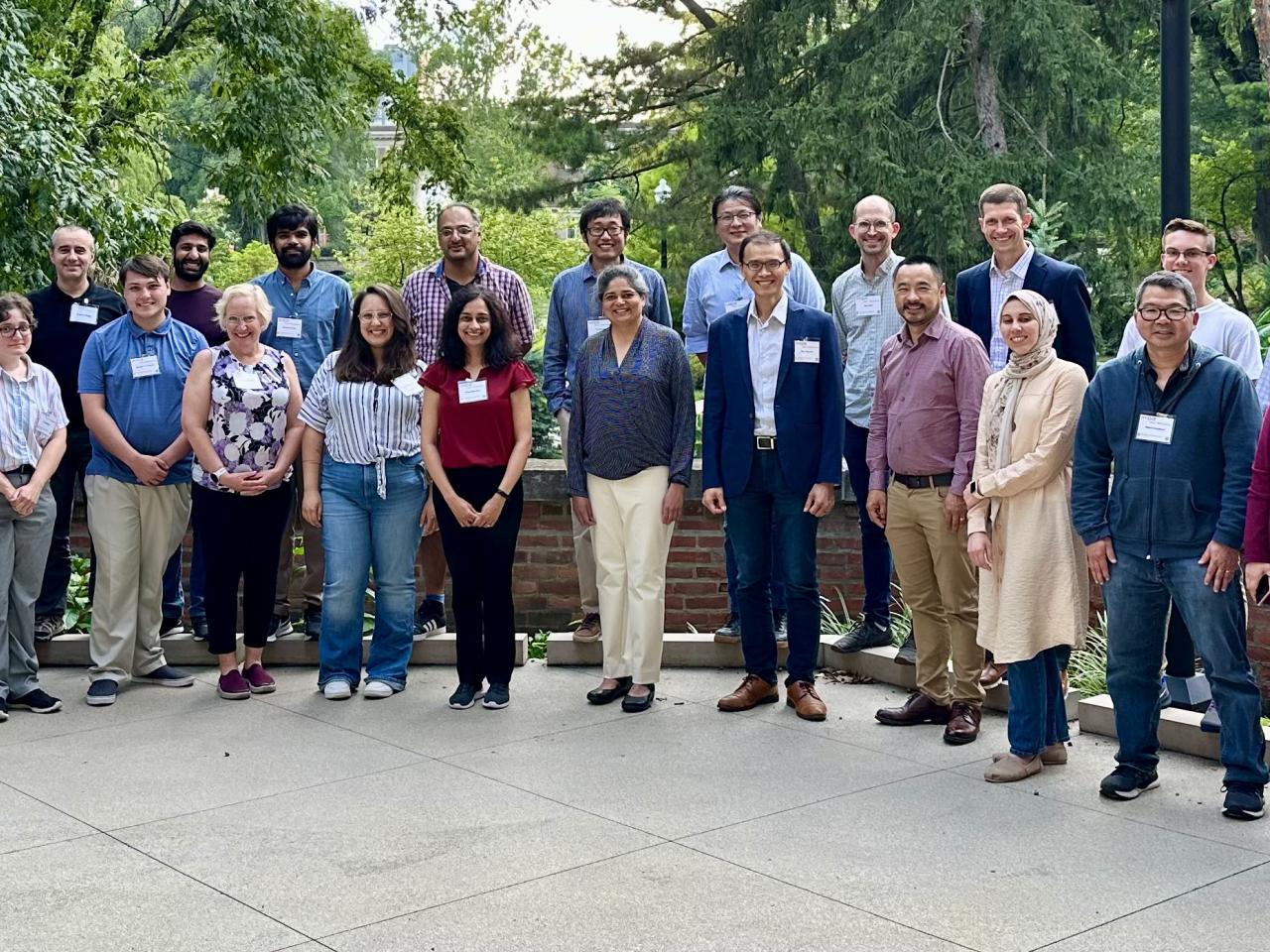 Attendees from the 2024 User Workshop standing on an outdoor patio.