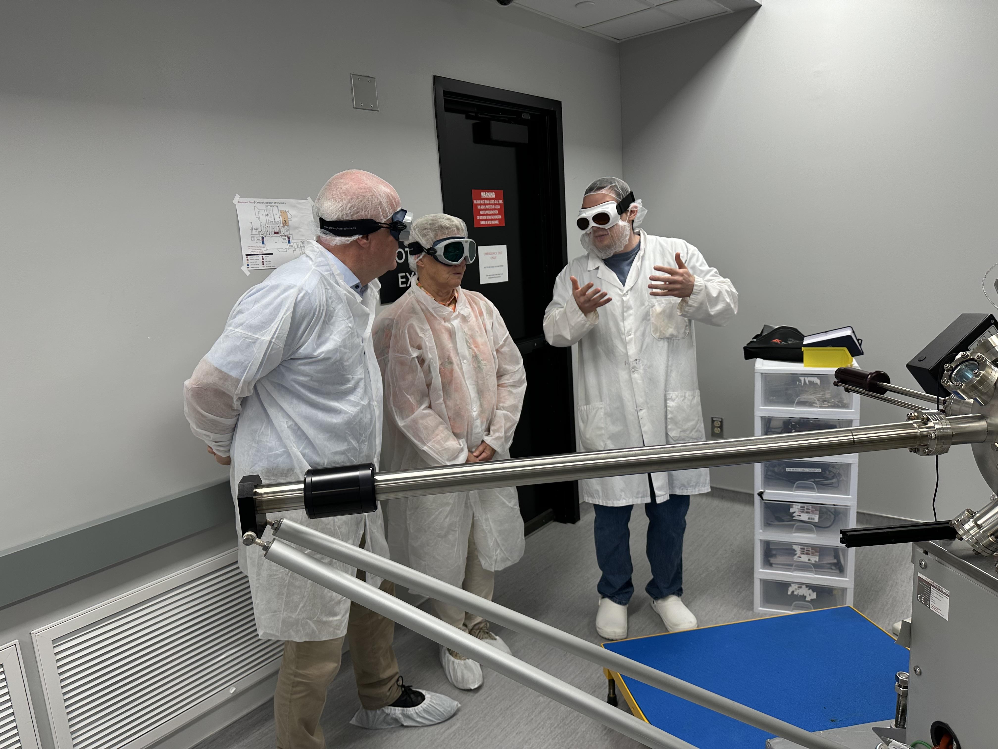 Anne L'Huillier and Claes-Goran Wahlstrom listen to Seth Shields describe the STM end station in the NeXUS lab