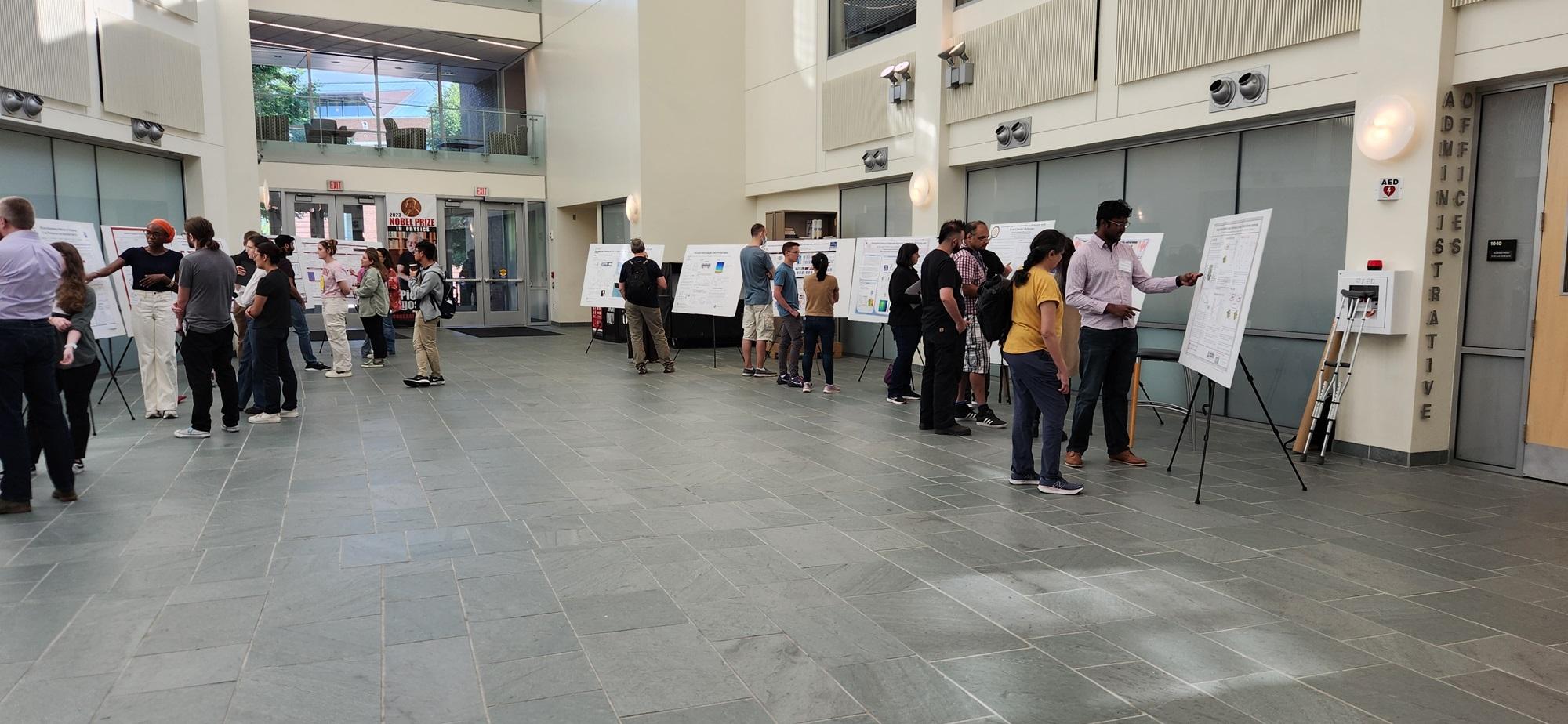 A group of students and presenters at a poster session