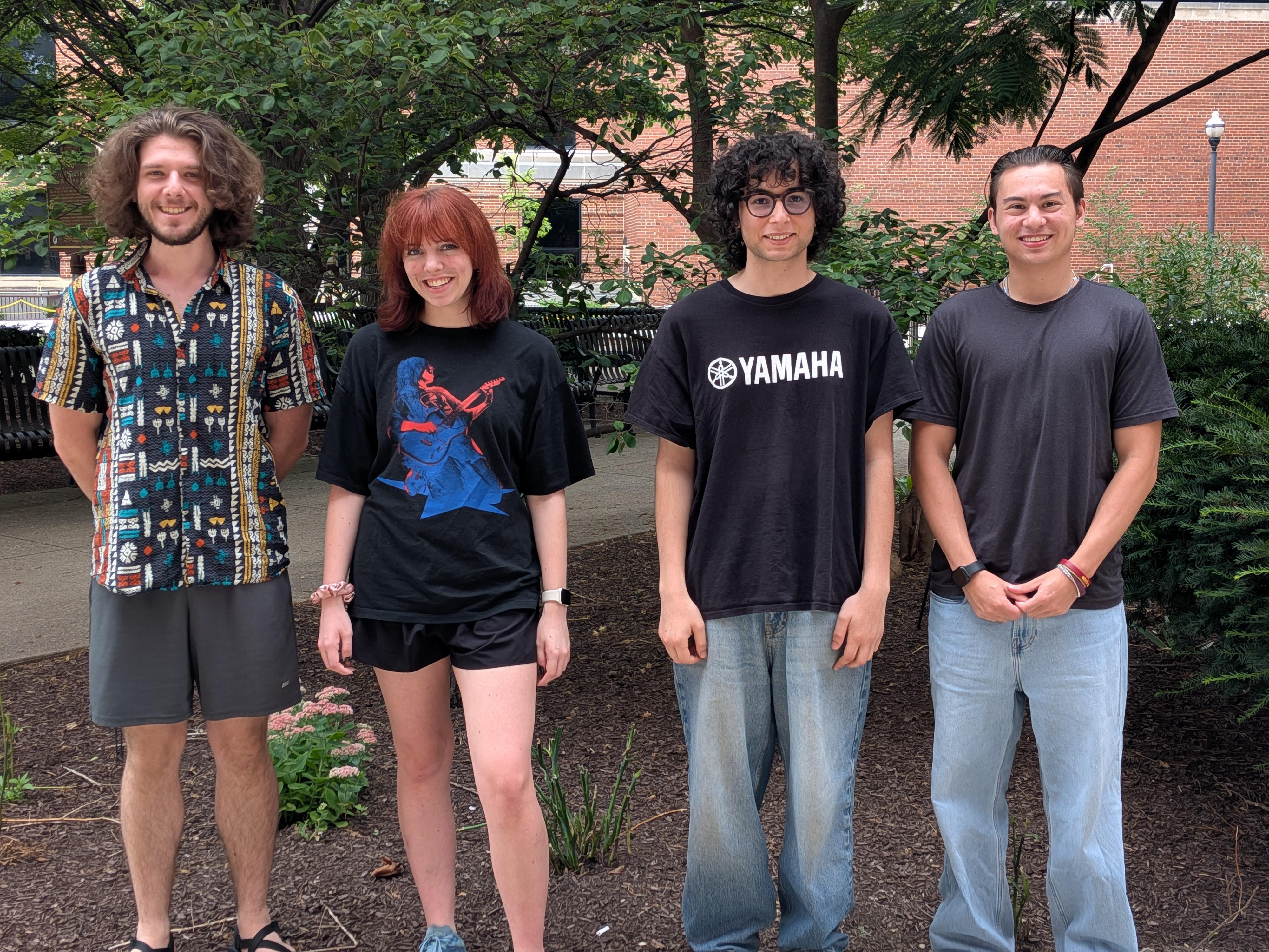 Four undergraduate students standing together outdoors