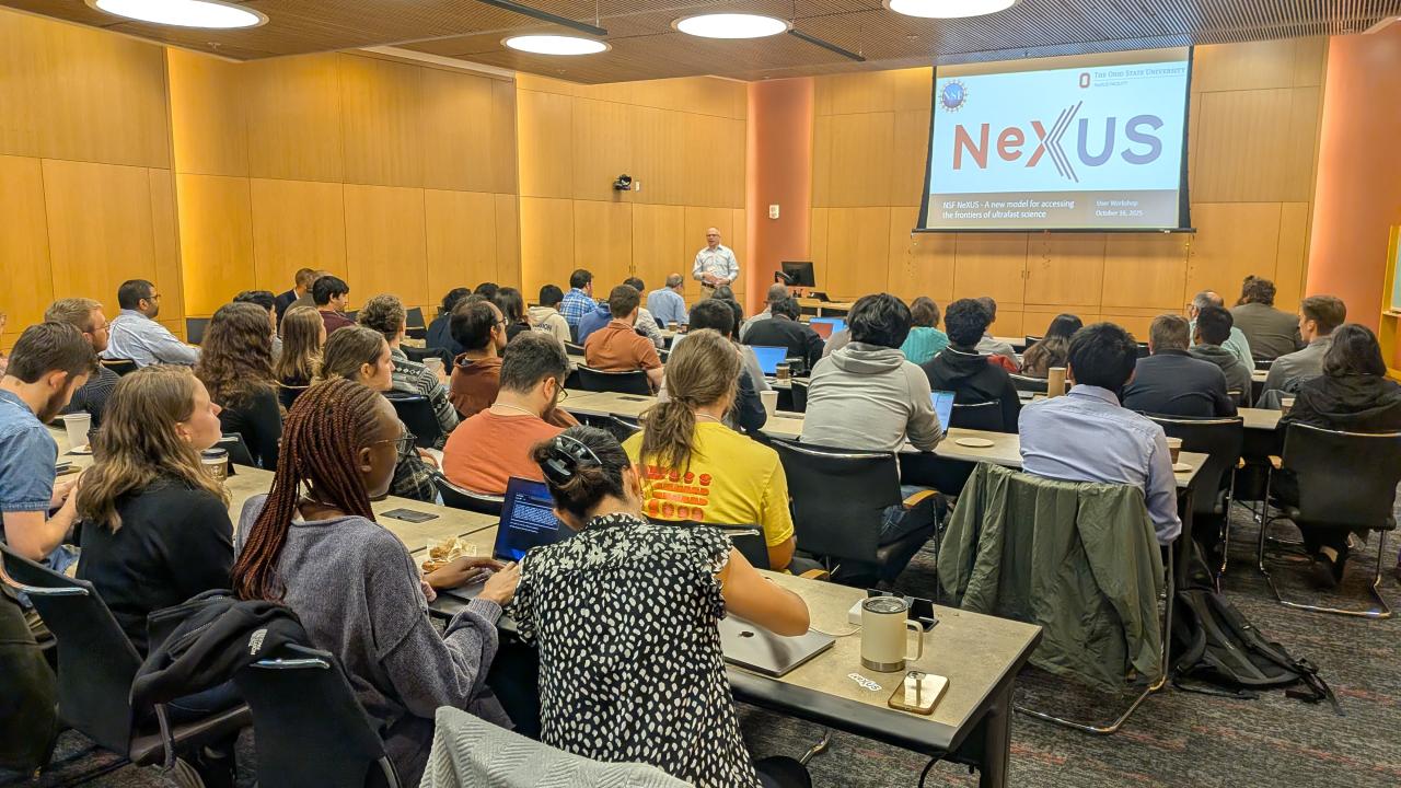 A conference room filled with people listens to a presenter at the NeXUS User Workshop