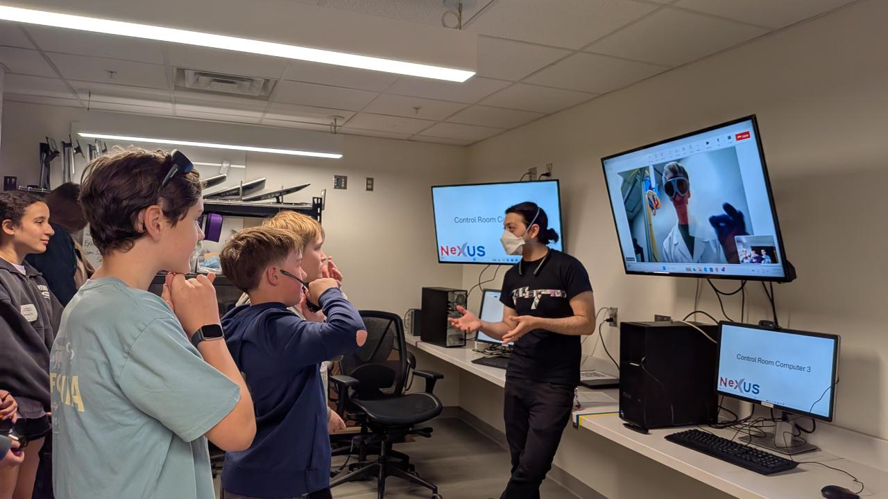 Research Scientist John Beetar talks about lasers with middle school students